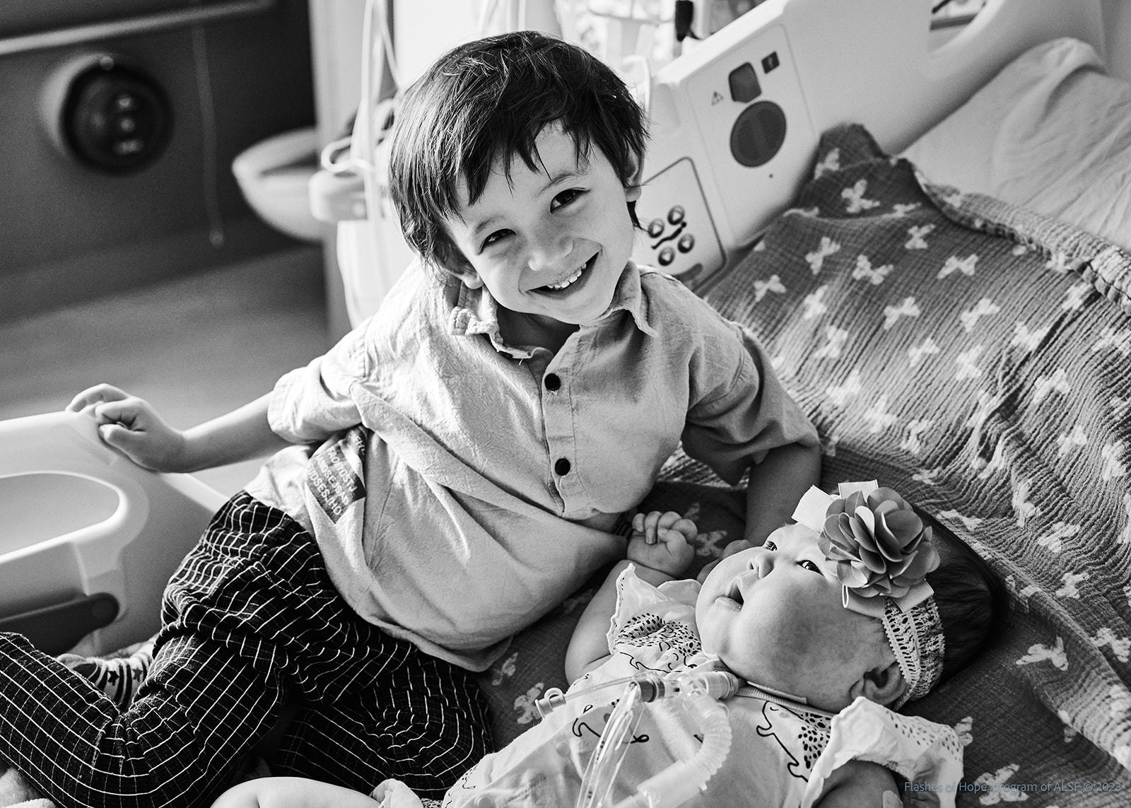 Black and white of Declan and Constance on a bed.